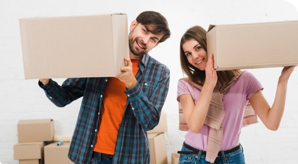 Happy people moving boxes